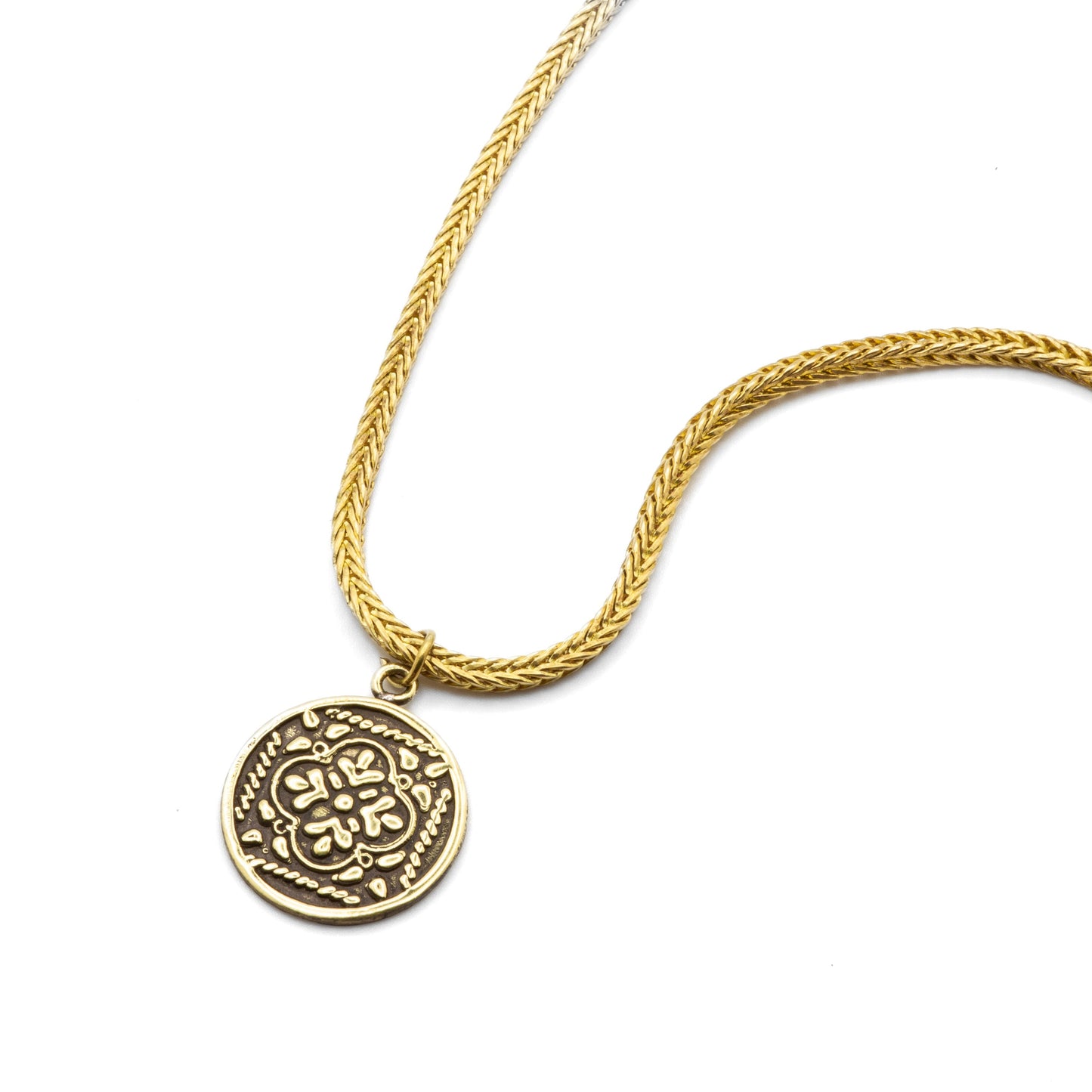 Flat lay detail of Maysa raw brass chain, showcasing inherited craftsmanship and natural patina